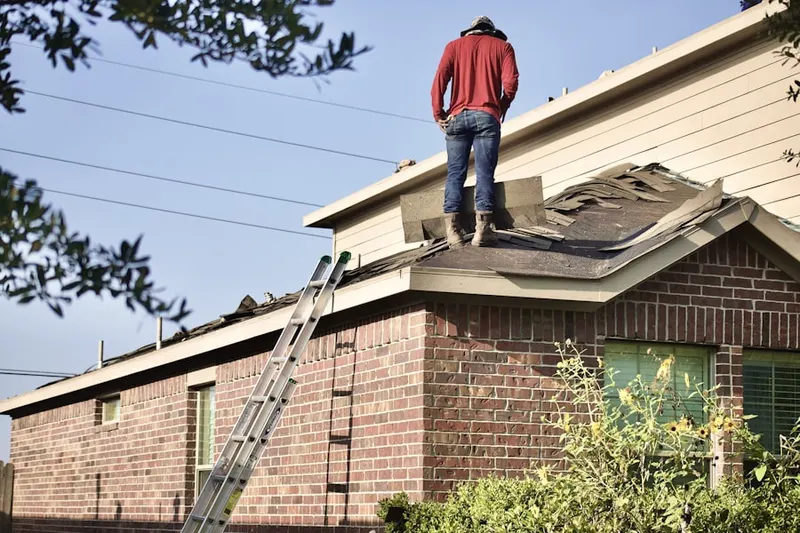 Professional roofer working on a residential roof in Brown Estates
